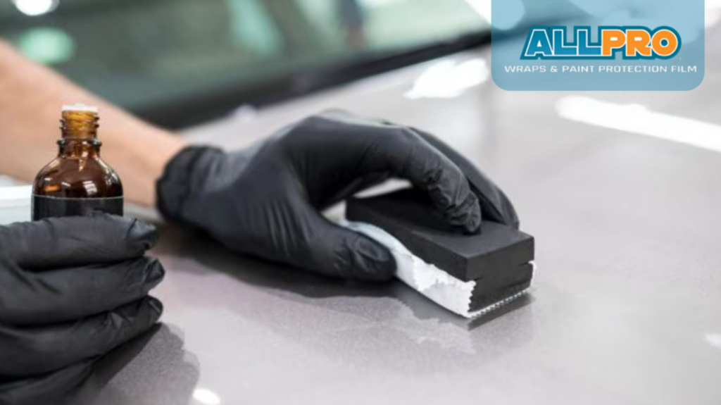 trained technician carefully applying ceramic coating to a car