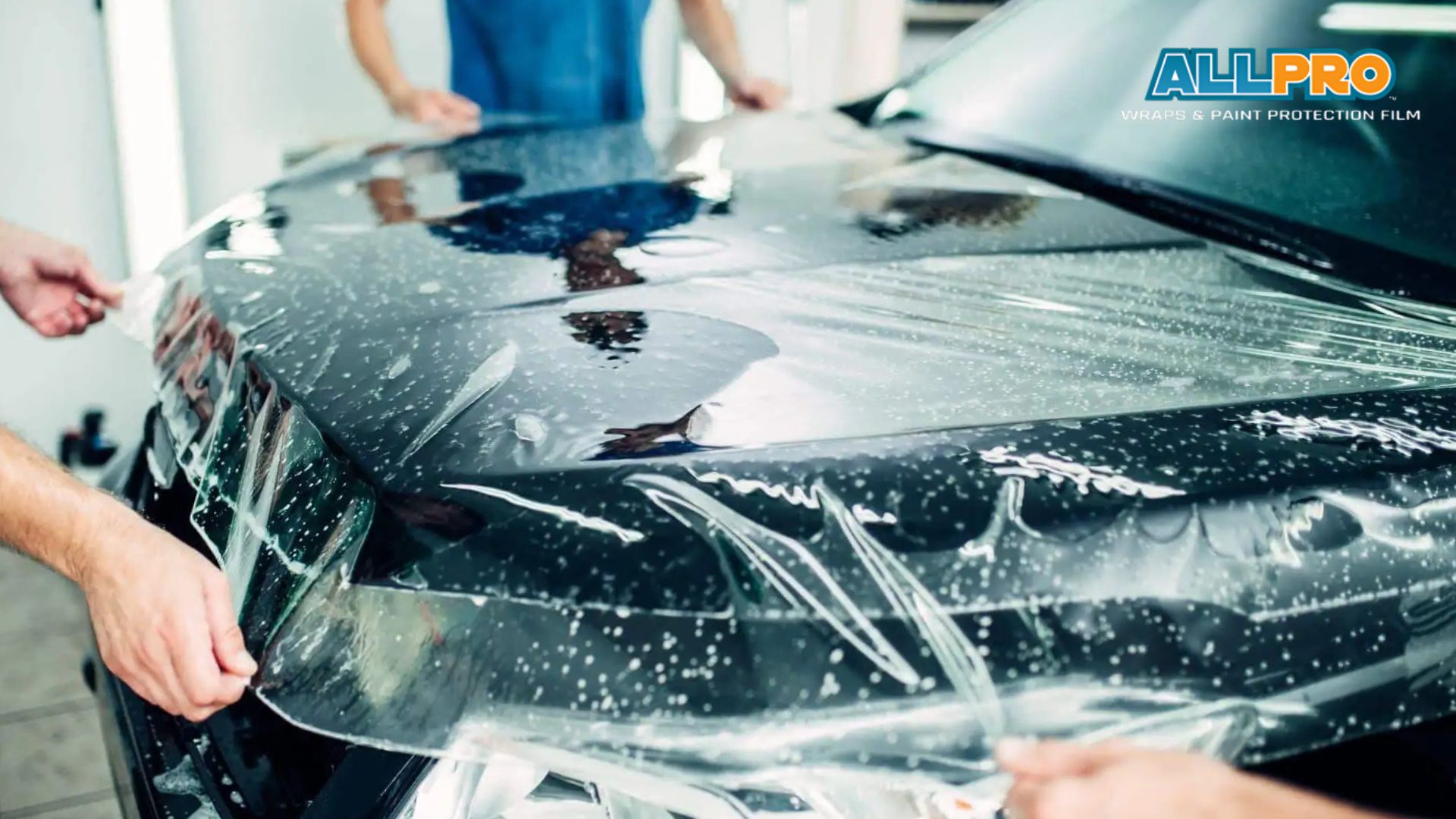 paint protection film is being applied professionally to a car